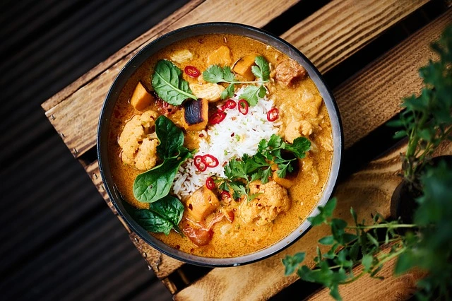 A bowl filled with
                    a delicious looking traditional curry in yellowish color.