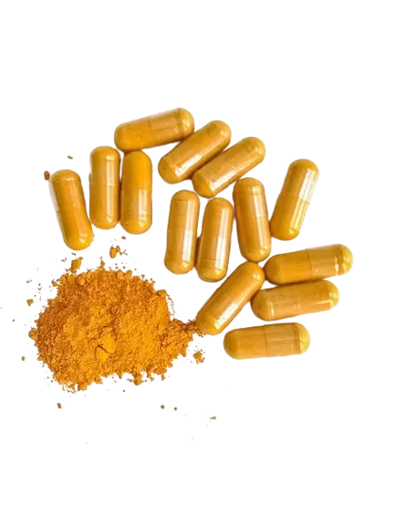 A few pills filled with turmeric
            next to powdered turmeric